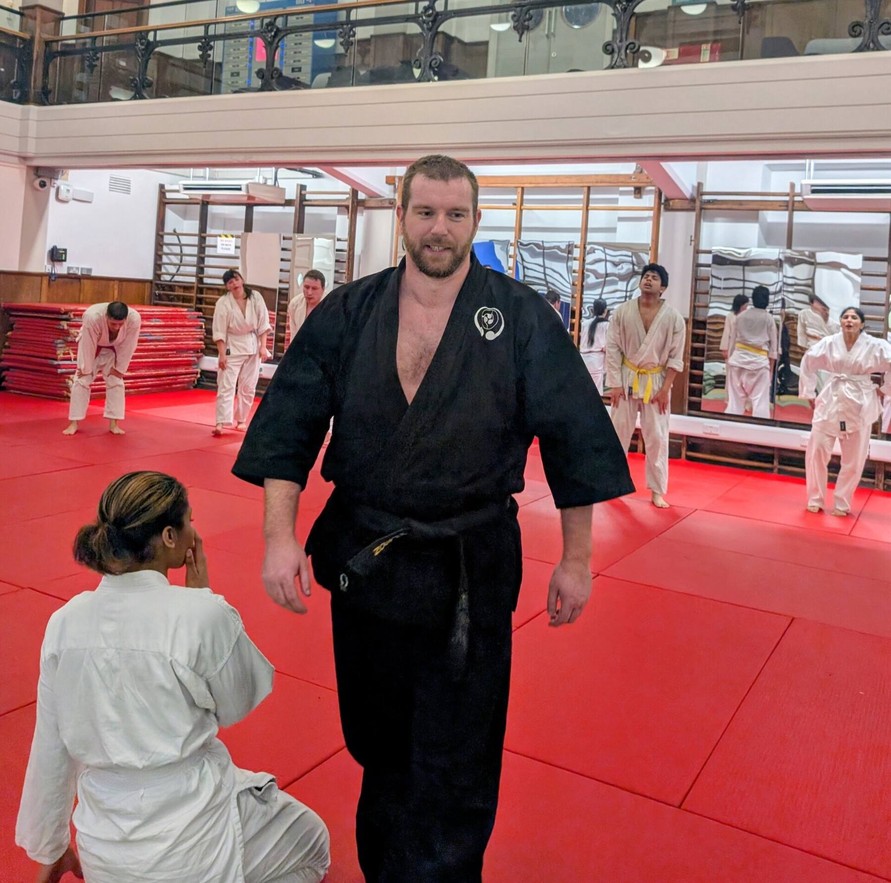 Black gi candid in dojo